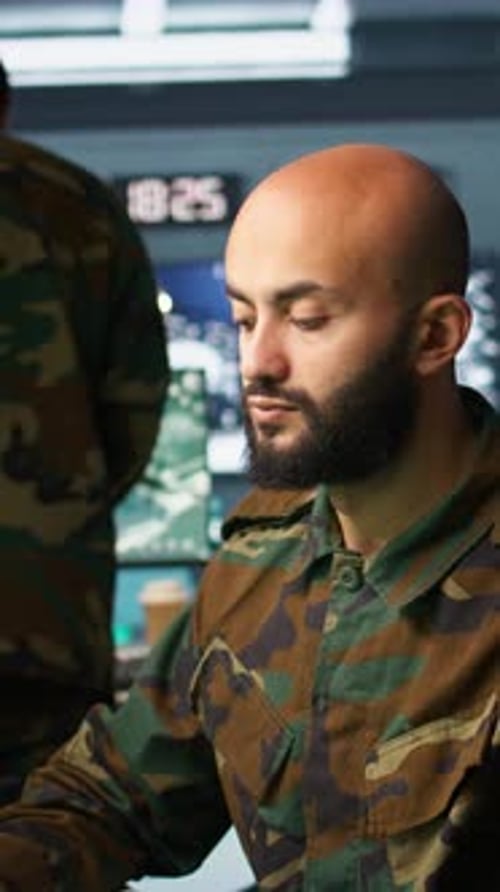 Man in Camouflage with Rifle and Computers