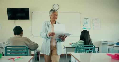 Teacher, students and giving paper in classroom for exam, test and assessment