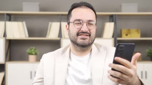 Man Celebrates While Looking at his Phone