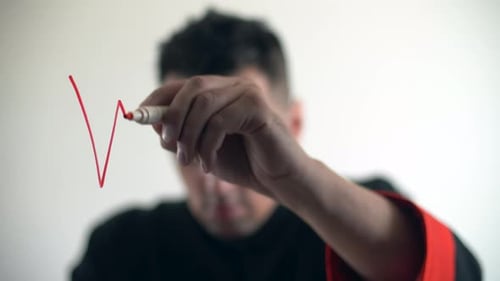 Young Adult Writing War in Red Marker