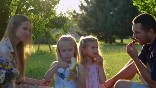 Close Up of Cute Blonde Little Girls on Family Picnic with Parents in Summer Caucasian Children are