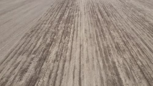 Blue tractor OA working on the field in Ukraine