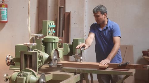 Man Using Woodworking Machine in Workshop, Crafting Wood