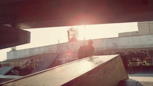 Young Skater Performing Trick on Skate Board at Modern City Skate Park