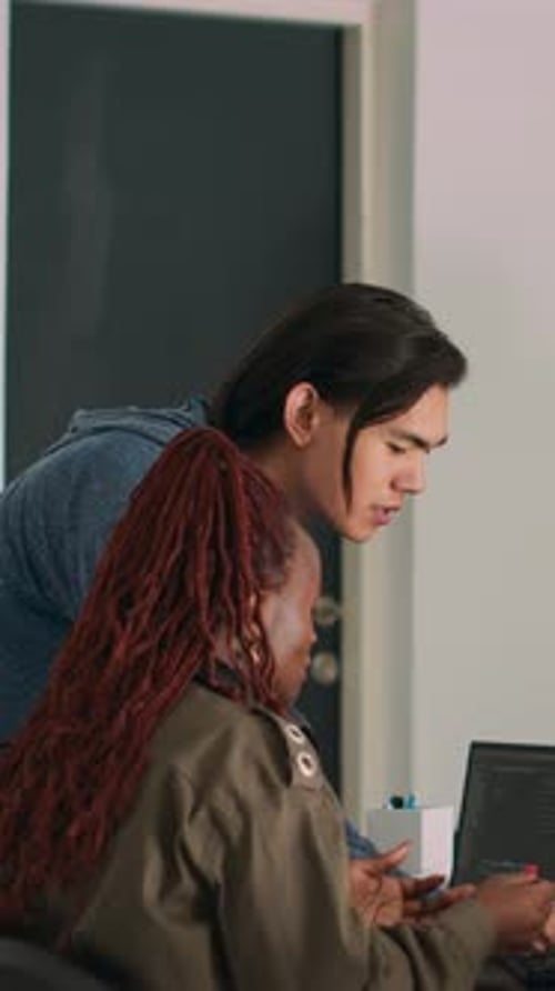 Two Coders Troubleshooting Error in Modern Office