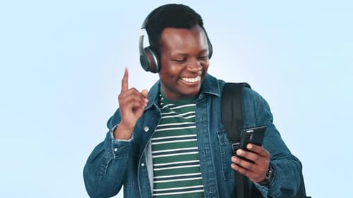Music, headphones and black man in studio with phone for streaming song, radio and audio