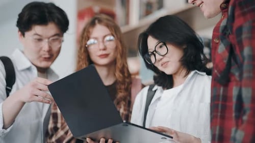 Group of diverse students studying together in a library
