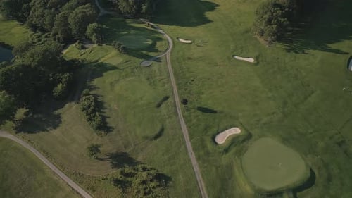 Aerial View of a Green Golf Course at Sunset