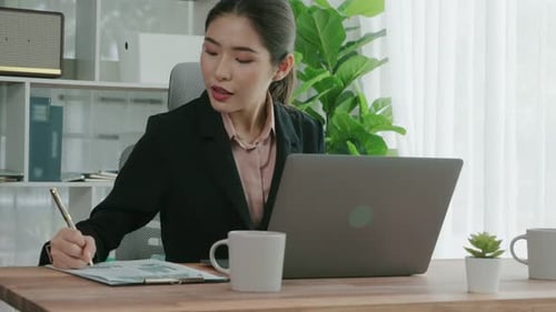 Enthusiastic Businesswoman Working and Typing Laptop in the Office