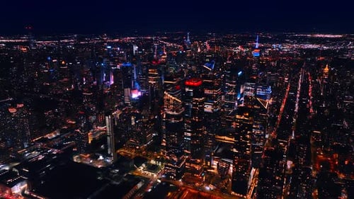 Flying over the luminous scenery of New York, the USA. Sparkling panorama of metropolis at night.