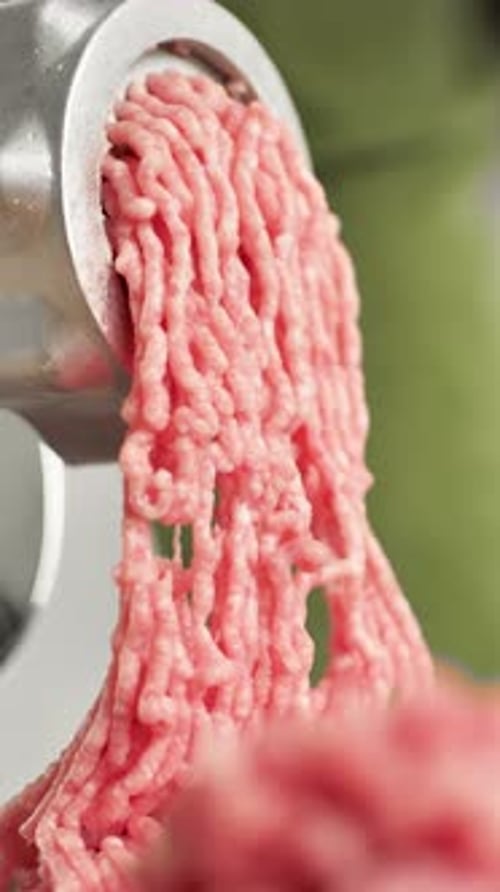 Vertical Video Red Chopped Meat Falling with Close Up Meat Grinders The Process of Using a Meat