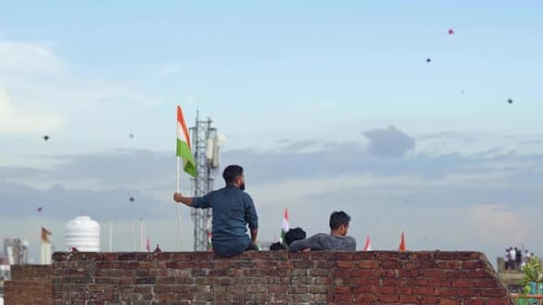 People Fly Kites with Indian Flags on Rooftop