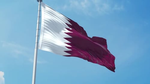Waving Qatar Flag on a Flagpole in Blue Sky