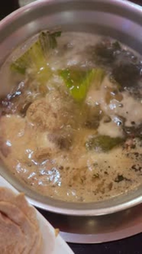 Bubbling Soup Pot With Greens Travel Food Scene In Roadside Kitchen Simmering Broth Infused With