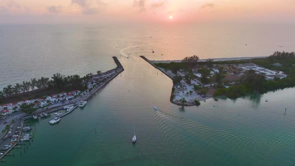 Sea Shore Inlet with White Yachts Sailing on Colorful Waves at Sunset ...