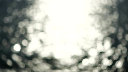 Abstract Shining Sun Reflections on Blue Surface of Sea Waves Bokeh Sun Glare Reflected in Water