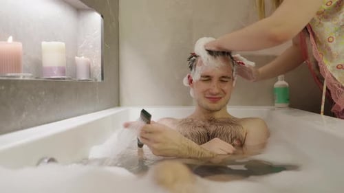 Young Adult Man Relaxing in Bubble Bath