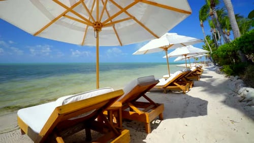 Tracking tropical turquoise ocean waters and beach chairs in the bahamas