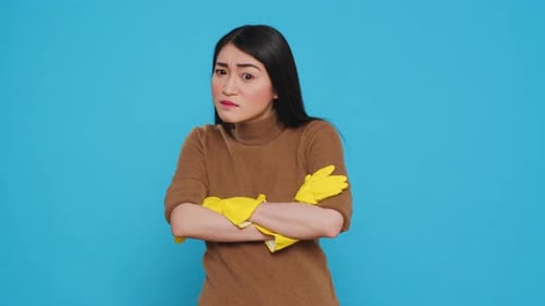 Woman Shivers in Yellow Cleaning Gloves