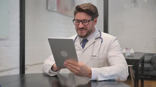 Doctor On Tablet Talking To Someone