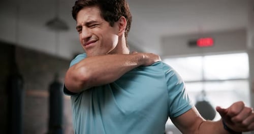 Frustrated man, shoulder and injury with pain at gym for accident during workout