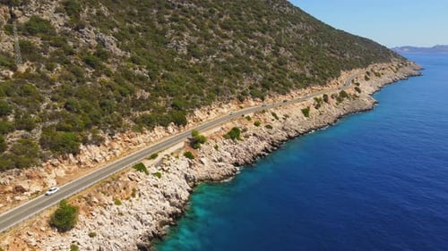 Aerial view of road, rocky sea coast with waves and stones Landscape with road,