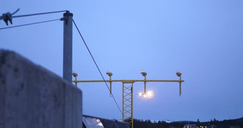An aircraft try to land on the runway during twilight / dawn hour at low altitude. Handheld clip of