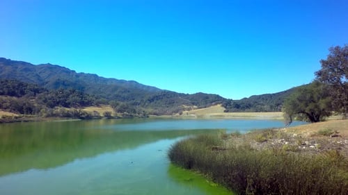 Aerial View of Gorgeous Mountainside Lake on Sunny Day 2 Above