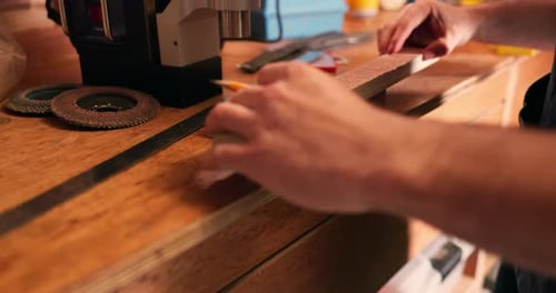 Carpenter hands, pencil and wood to measure size for construction, furniture or project