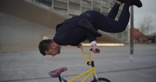 Young Adult Performs BMX Stunt on Bicycle