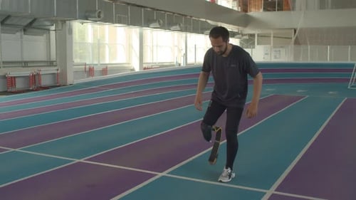 Male Athlete with Running Blade Preparing to Start Run