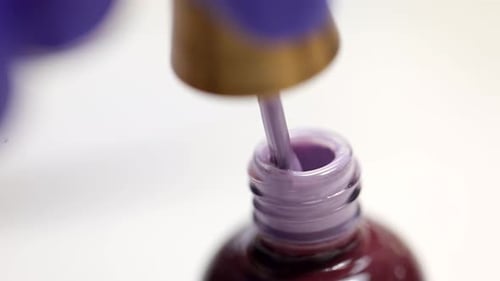 Macro Shot of Manicurist Opening Nail Polish