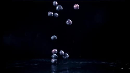 Blueberries Falling in Slow Motion on Black Surface