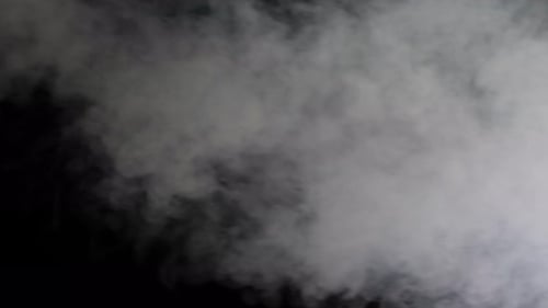 White Smoke Billowing Against Black Background