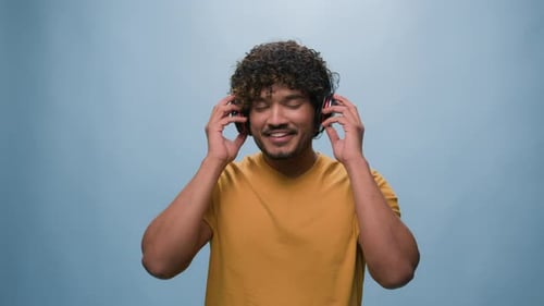 Studio Portrait Happy Arabian Man Indian Guy Hispanic Male Put on Headphones Listening to Music