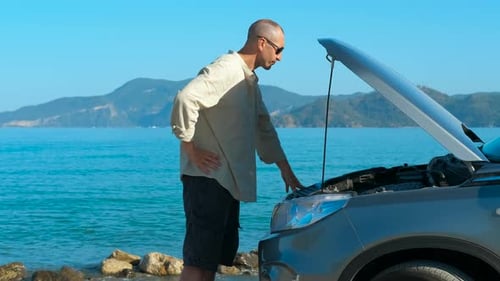 Upset Man with Broken Car By the Sea