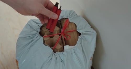Hands Securing Red String Around Package Delivery