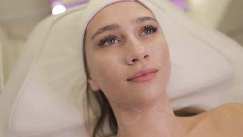 Woman Enjoying Stress Relief and Facial Rejuvenation at Luxury Spa