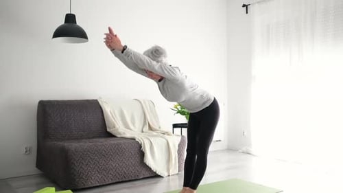 Woman Doing Yoga at Home on Exercise Mat