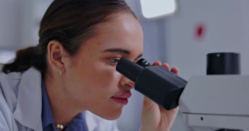 Microscope, search and science with woman in laboratory for research, virus and breakthrough