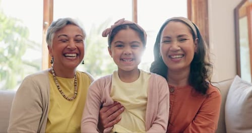 Three Generations of Family Smiling Together Indoors