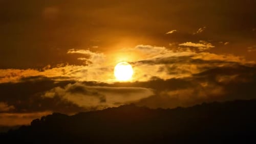 Golden Sunset Time Lapse Behind Dark Mountain