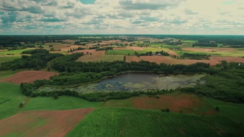 Beautifil water pond in the country, surrounded by forests and meadows