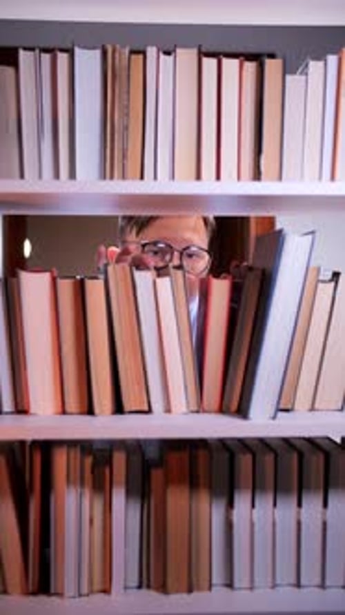 Vertical Video Librarian Searching Bookshelf Looking for Book in Library