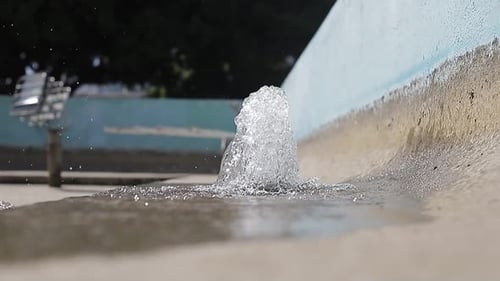 Front view of jets of water from city fountain in park. slow motion shot.