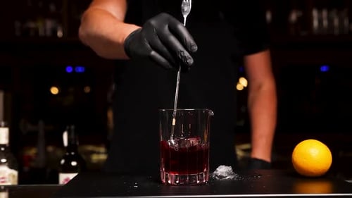 the bartender prepares a cocktail at the bar
