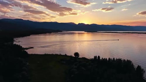 Aerial view of lone boat out on a lake in Montana during sunset