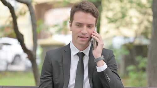 Businessman Talking on Phone Outdoors