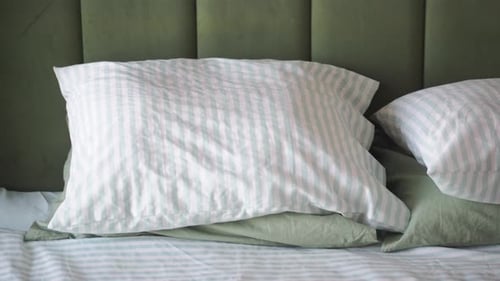 Bedroom Interior with Pillows and Striped Bedding