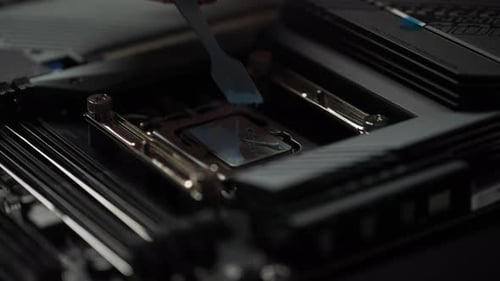 Technician Applies Thermal Paste to Computer CPU Socket